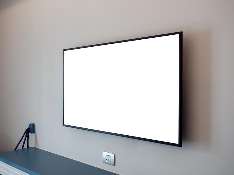 tv-screen-wall-near-plug-empty-shelf-hotel-bedroom